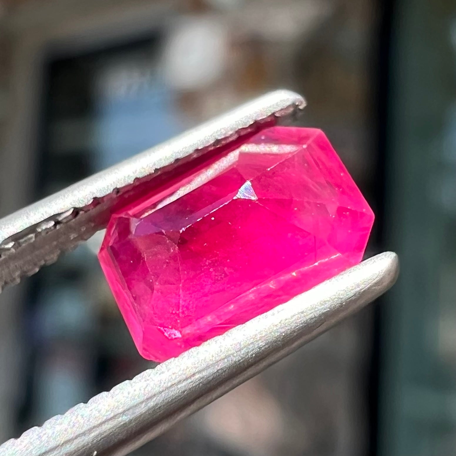 A natural, emerald cut Burma ruby gemstone.  The stone is pinkish red color.