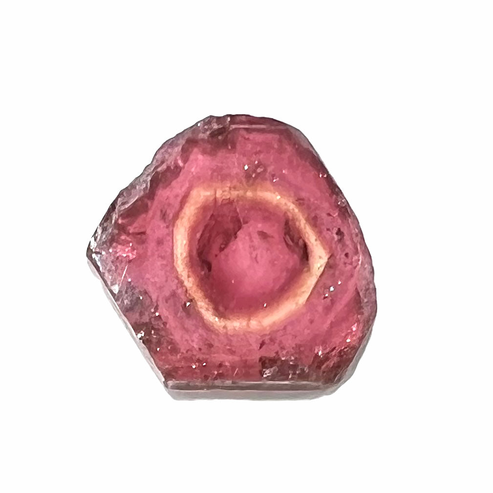 A polished bicolor pink tourmaline crystal slice.