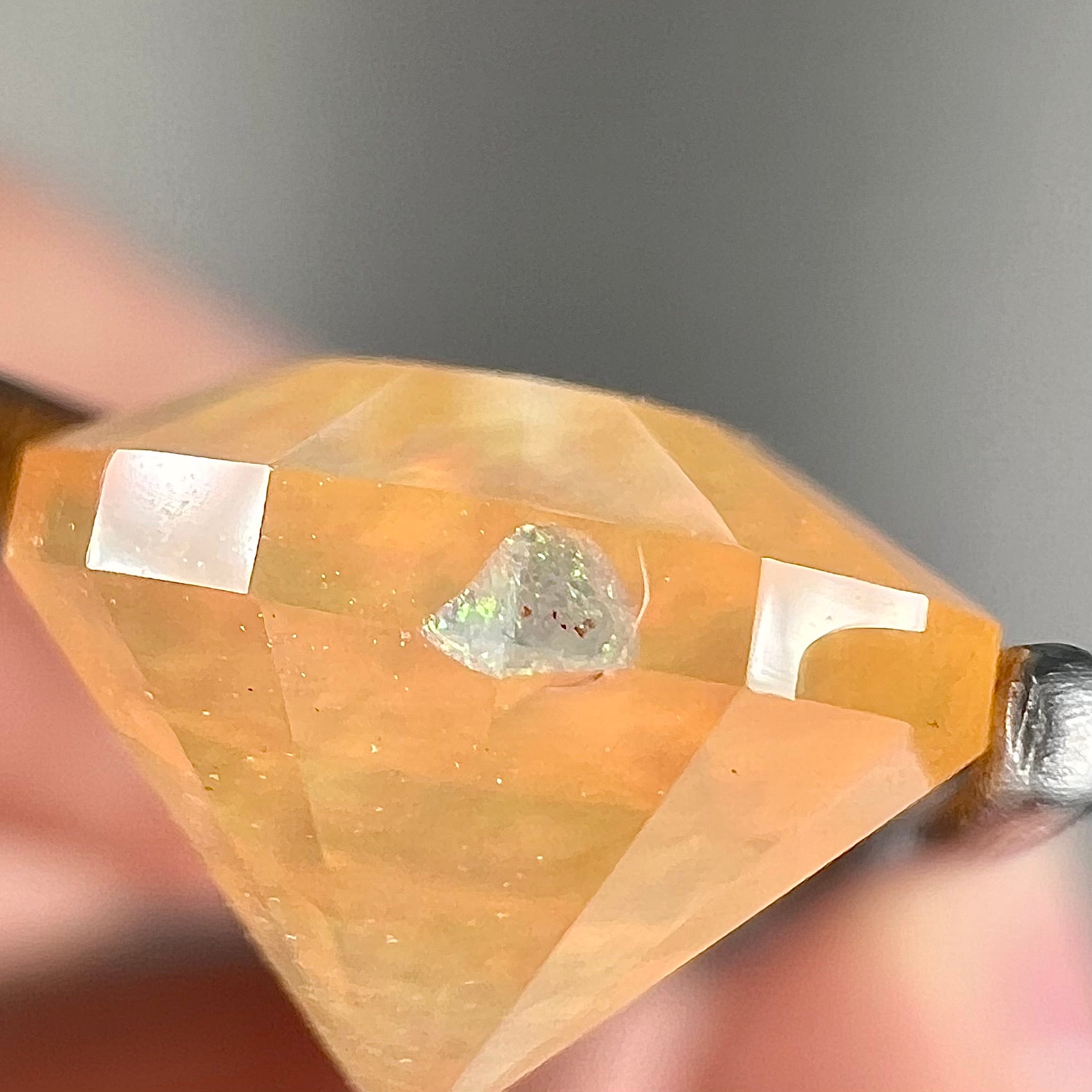 A loose, faceted round cut fire opal from Mexico.  The stone is yellow orange in body color.