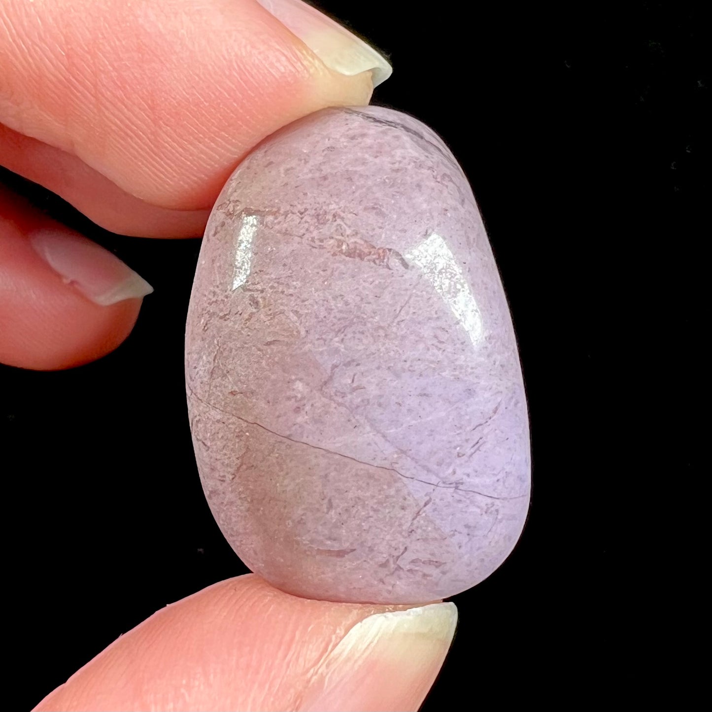 A tumble polished turkiyenite purple jade stone from Bursa, Turkey.