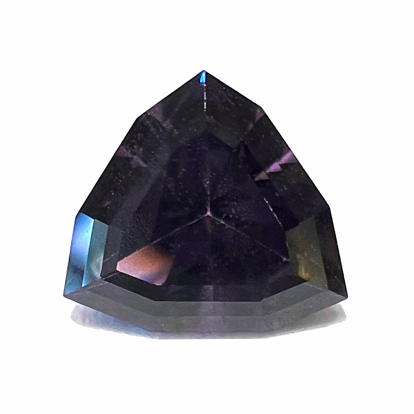 A loose, natural purple trillion cut spinel gemstone.  The spinel weighs 2.38 carats.
