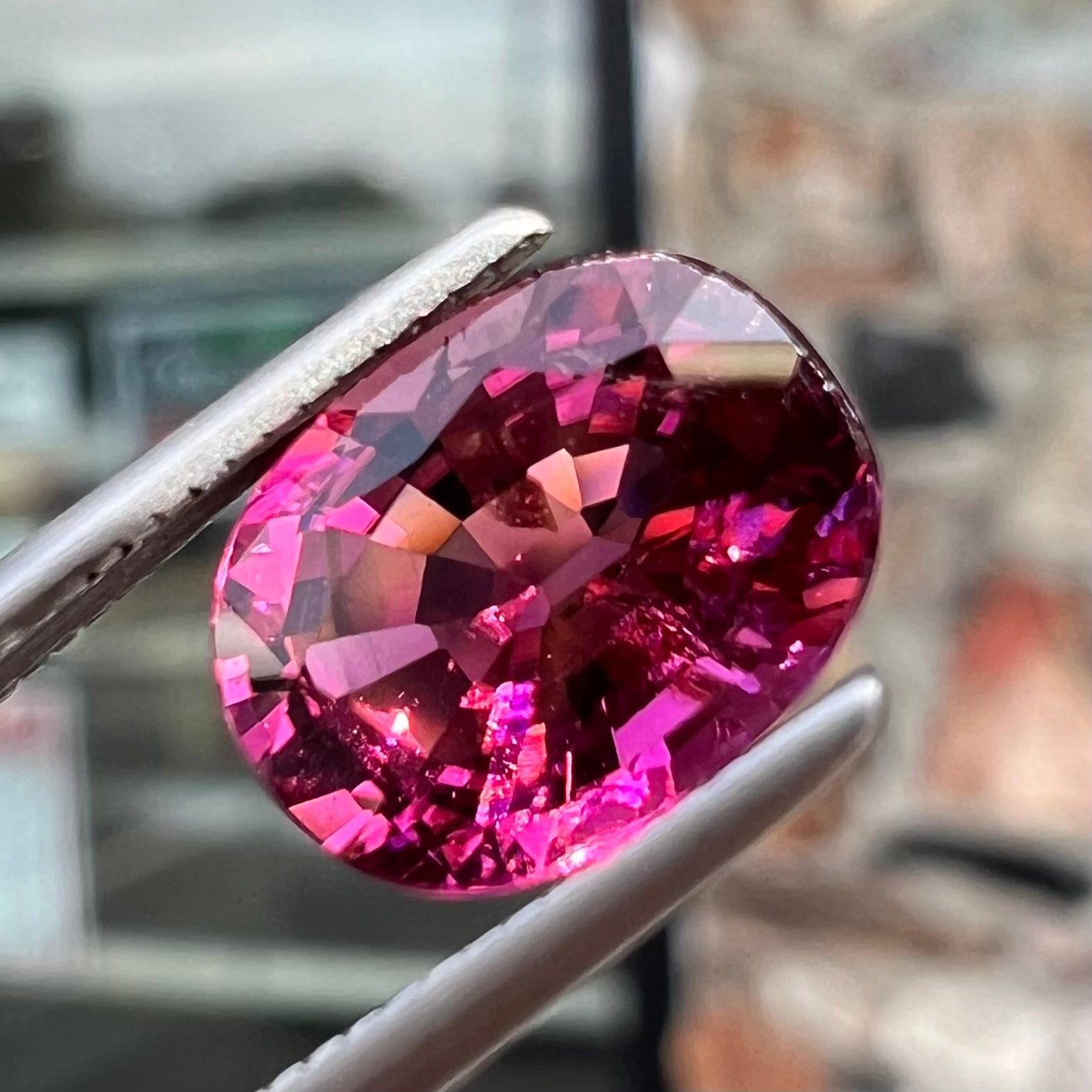 A loose, faceted oval cut purple tourmaline gemstone.  The stone weighs 2.08 carats.