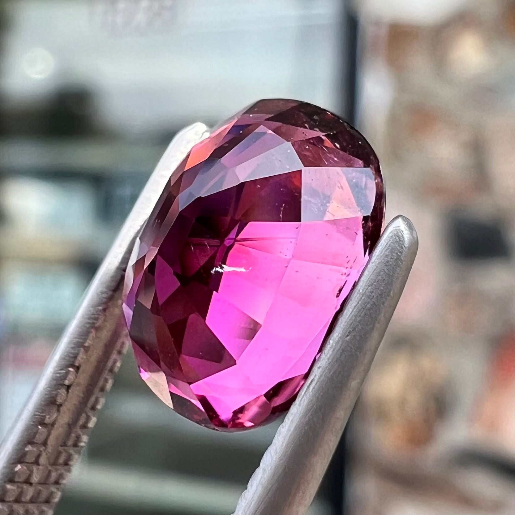 A loose, faceted oval cut purple tourmaline gemstone.  The stone weighs 2.08 carats.