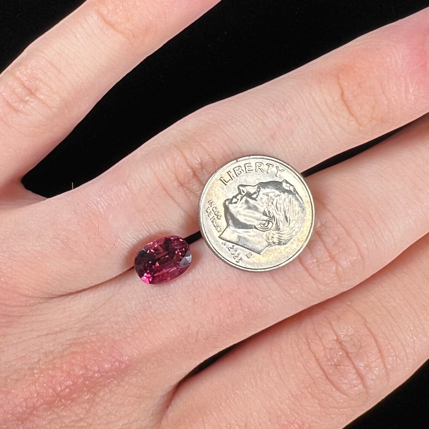 A loose, faceted oval cut purple tourmaline gemstone.  The stone weighs 2.08 carats.