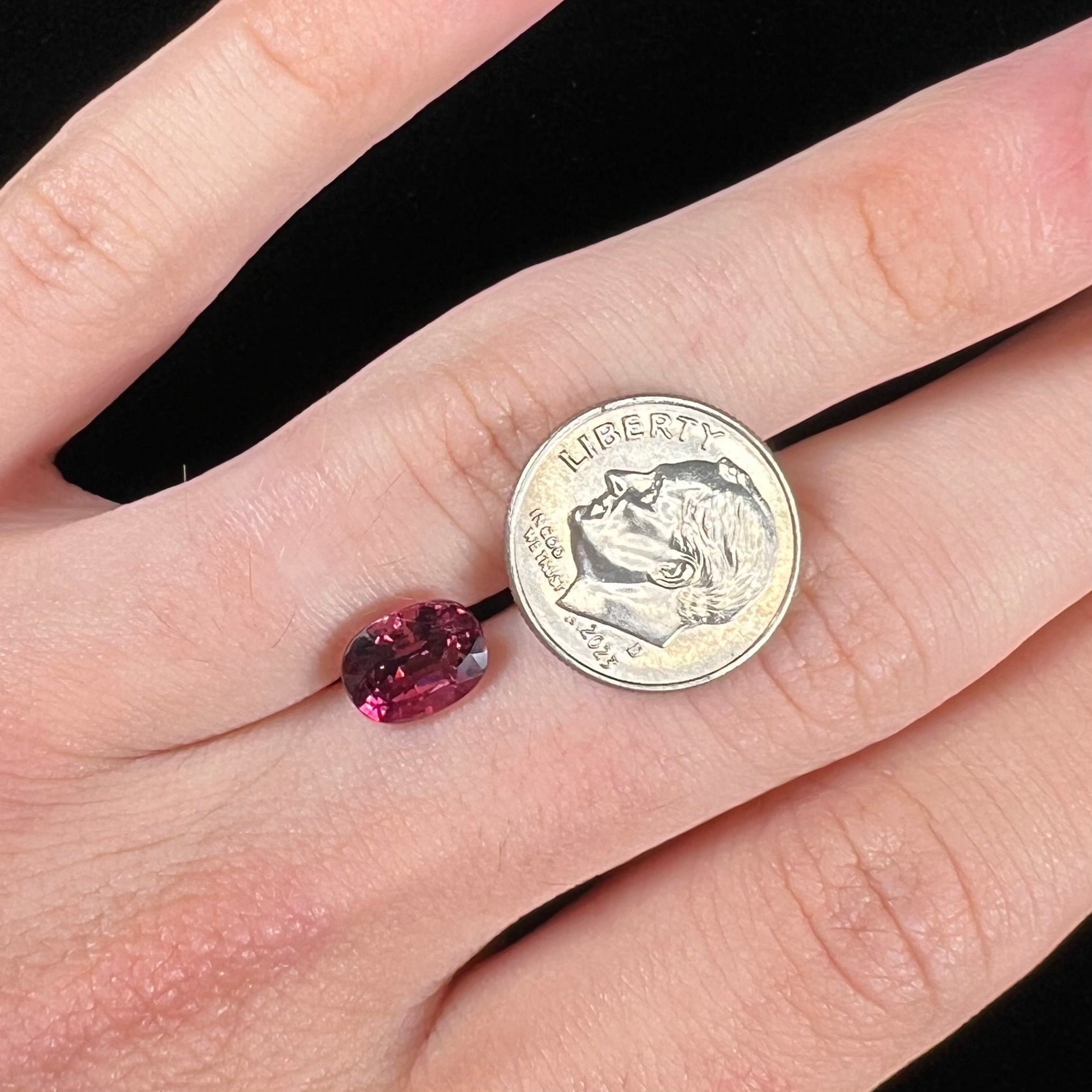 A loose, faceted oval cut purple tourmaline gemstone.  The stone weighs 2.08 carats.