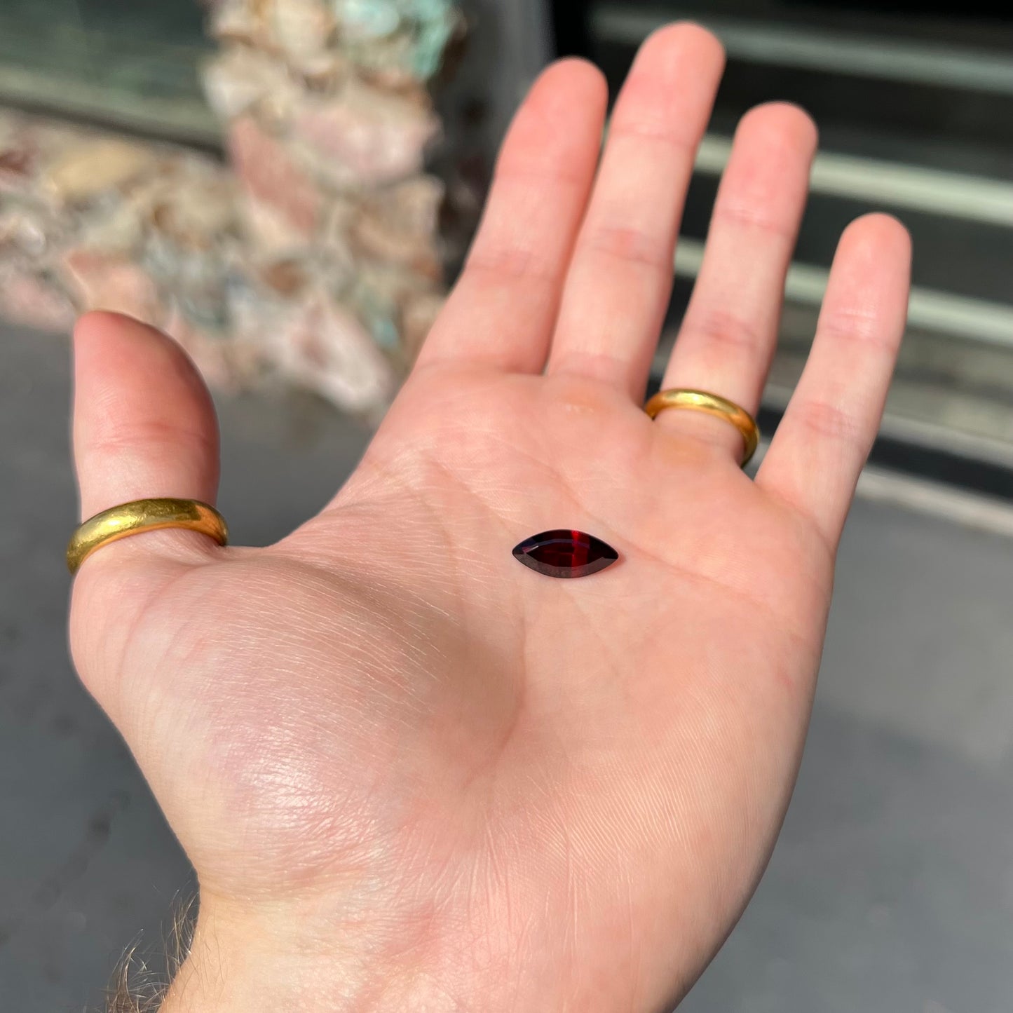 A faceted marquise cut red pyrope garnet stone.