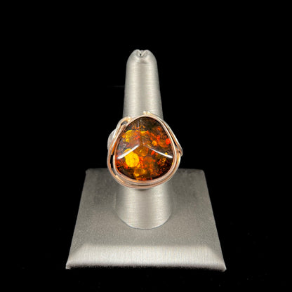 Unisex sterling silver ring set with a large sun-spangled Baltic amber gemstone.