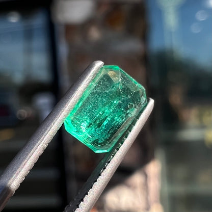 A loose, natural emerald gemstone.  The stone is emerald cut.