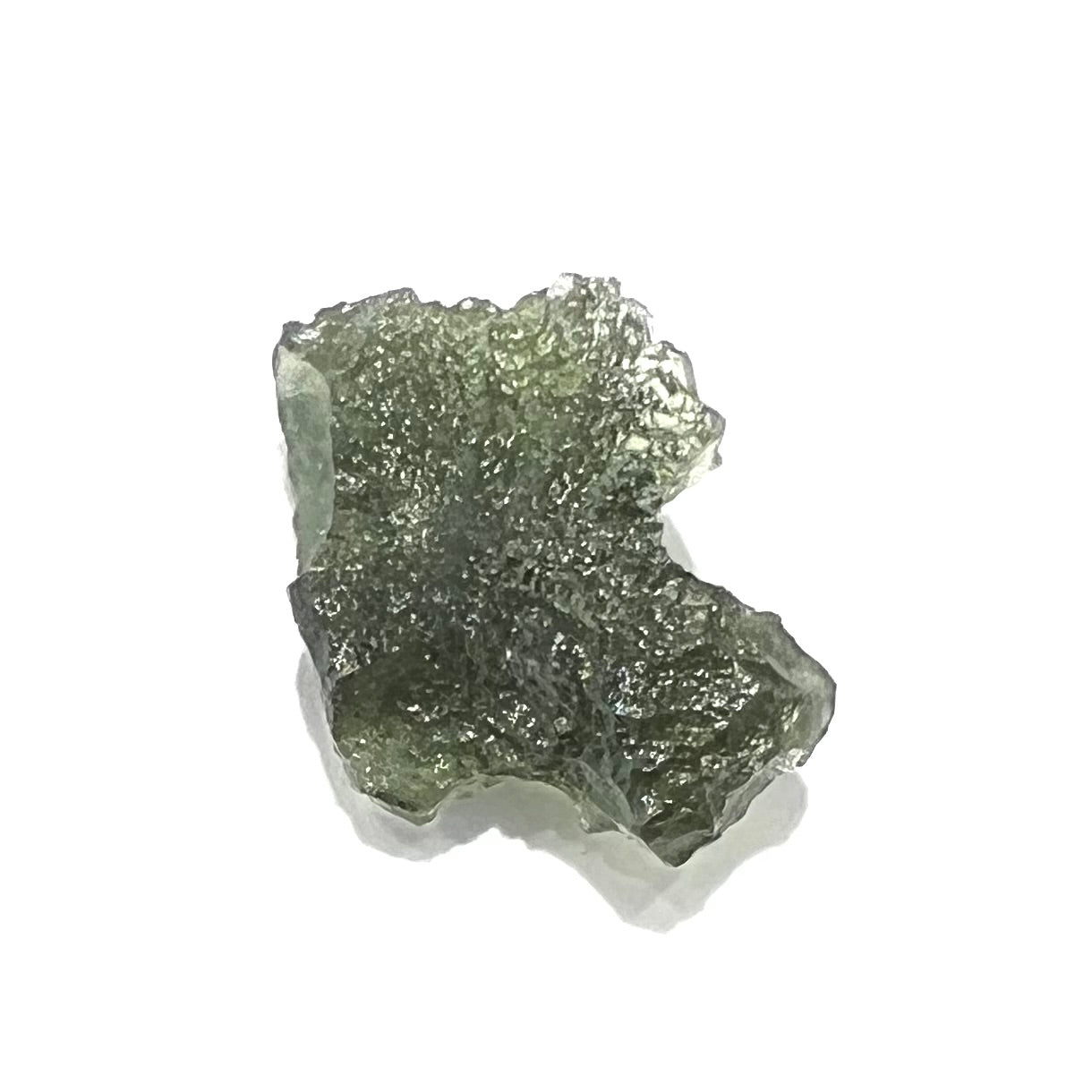 A natural, rough moldavite crystal.  The stone is green color and transluscent.