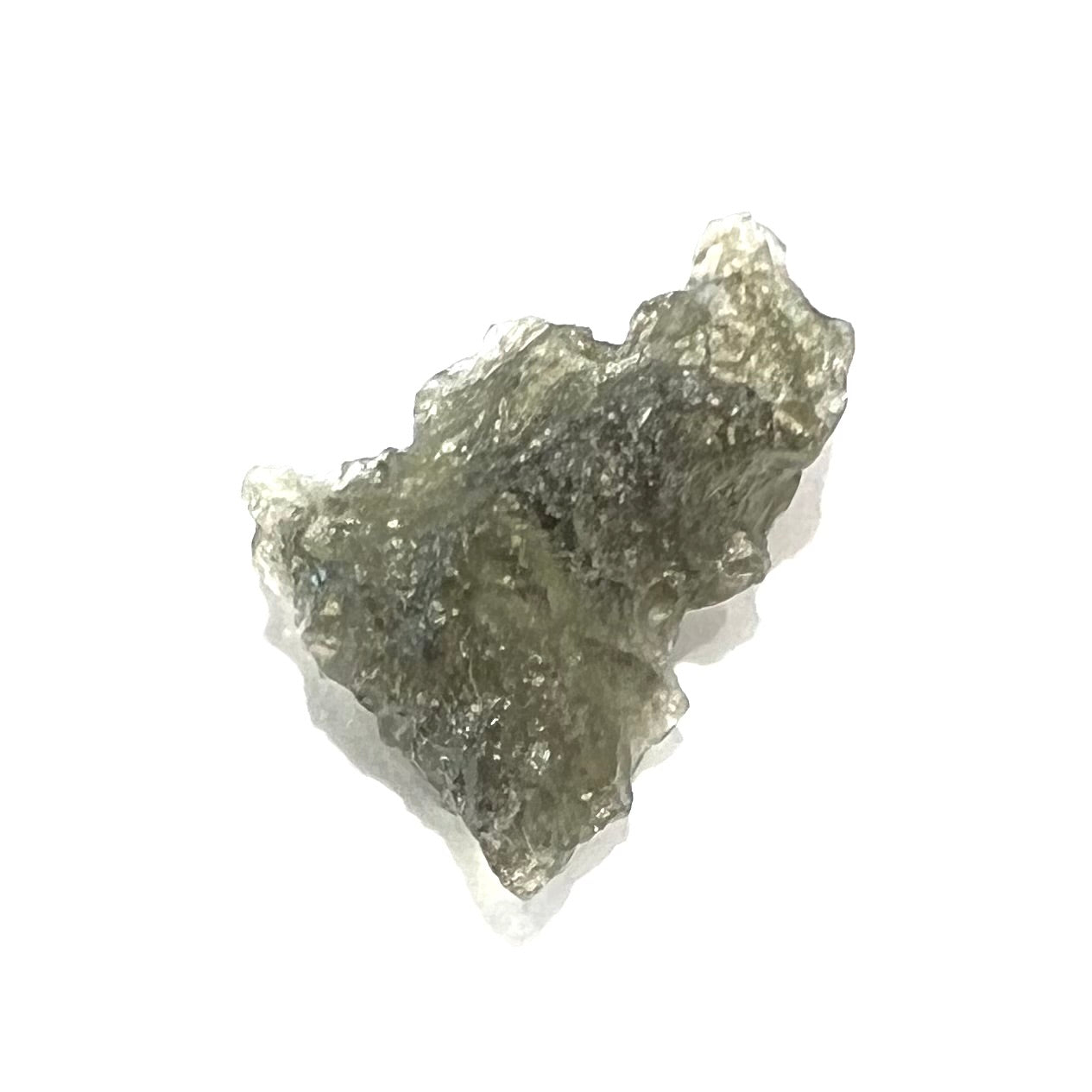 A natural, rough moldavite crystal.  The stone is green color and transluscent.