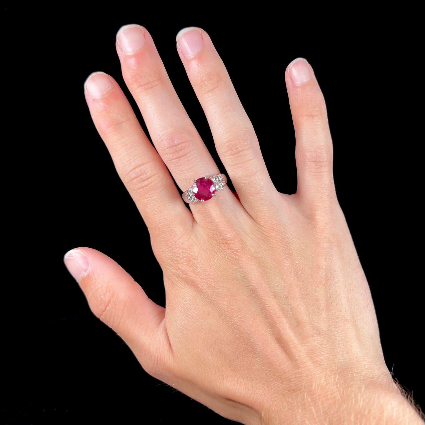 A ladies' sterling silver natural ruby and white zircon ring.  The real ruby is glass filled.