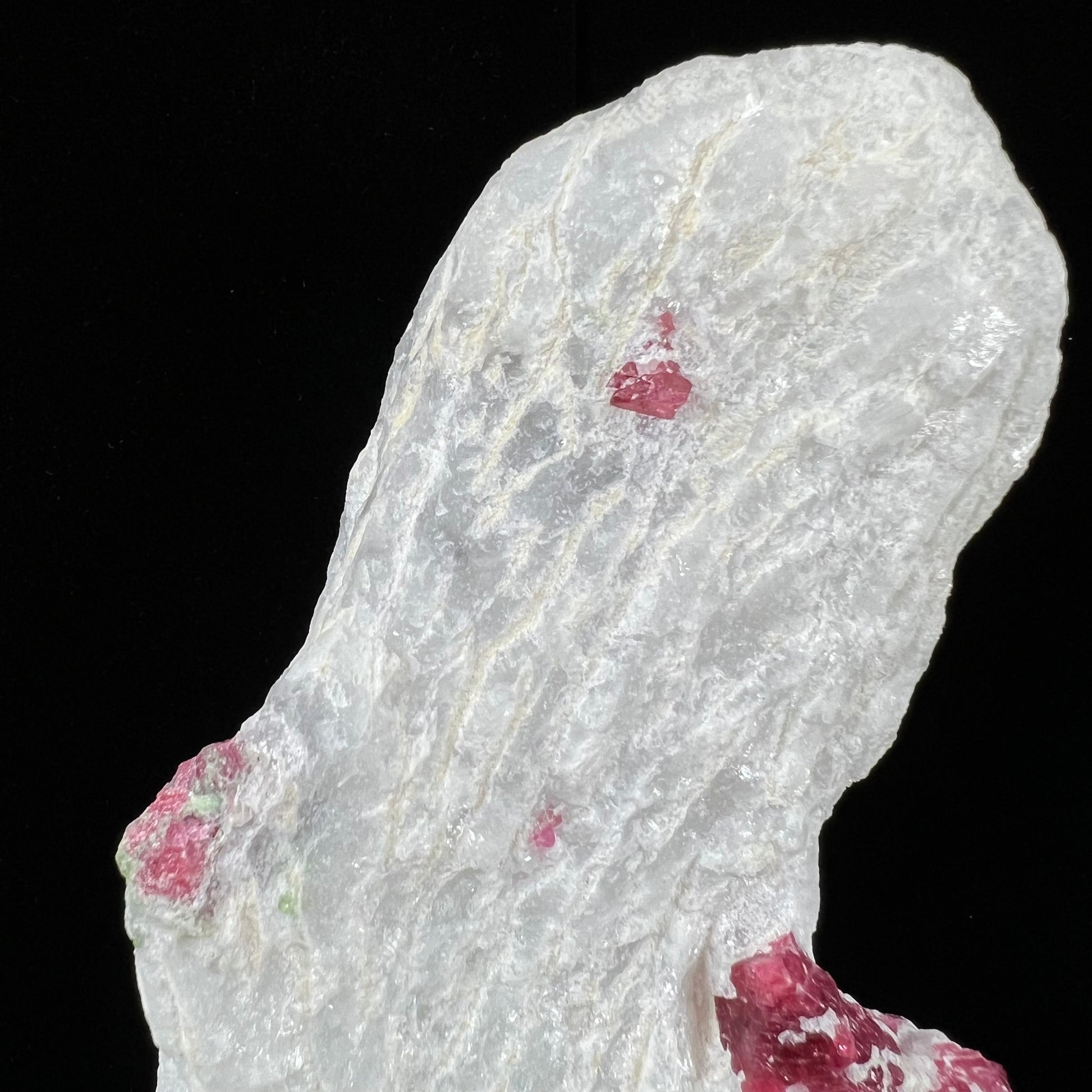 Red spinel crystals embedded in white calcite matrix from Luc Yen District, Vietnam.