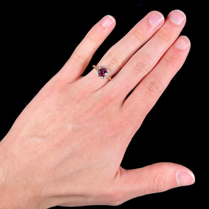A ladies' yellow gold Art Deco style solitaire ring set with a purple rhodolite garnet gemstone.