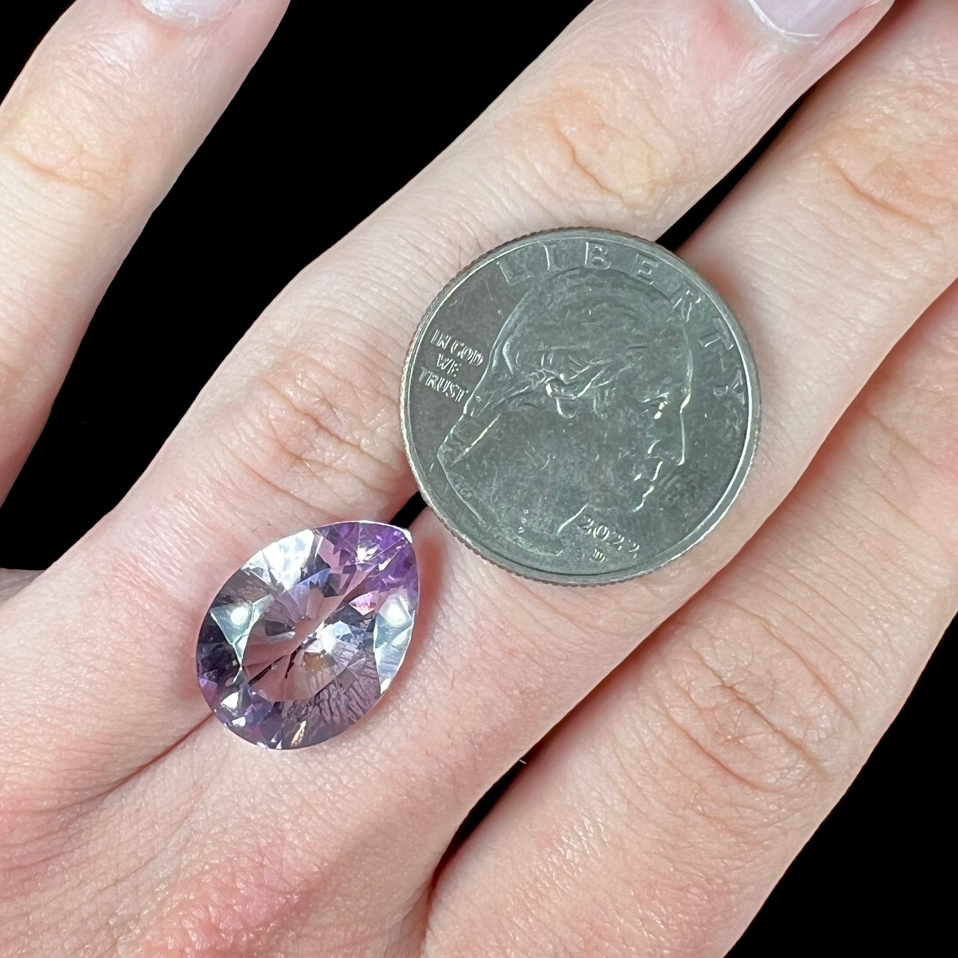 A faceted pear shaped rose de France colored amethyst gemstone.