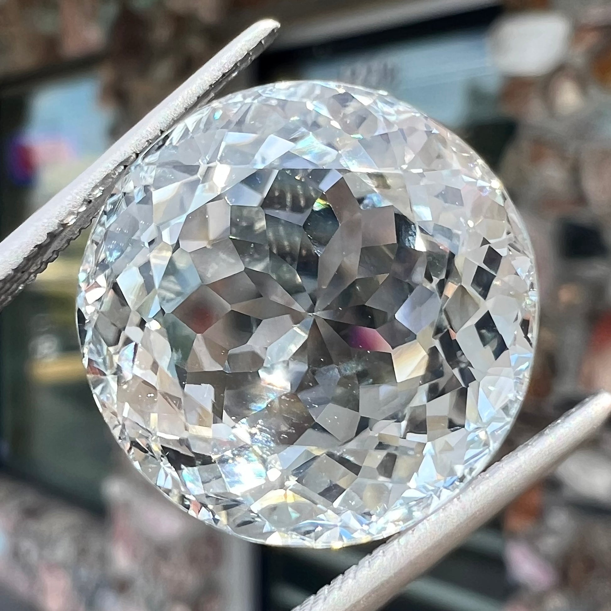A large, round brilliant cut white topaz gemstone.