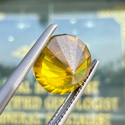 A loose, modified round brilliant cut sphalerite gemstone.