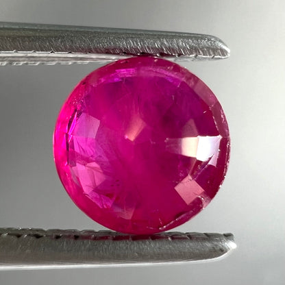 A faceted round brilliant cut Burma ruby gemstone.  The stone is certified as natural by Guild Laboratories.