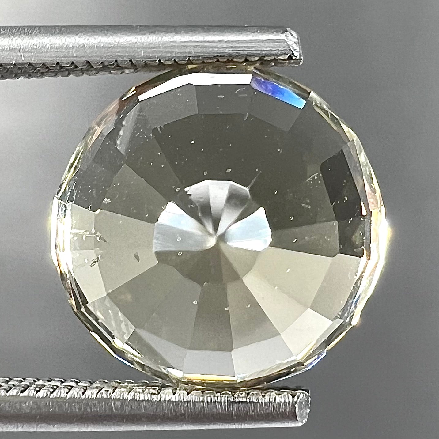 A loose, round brilliant cut citrine gemstone.  The stone is light yellow color.