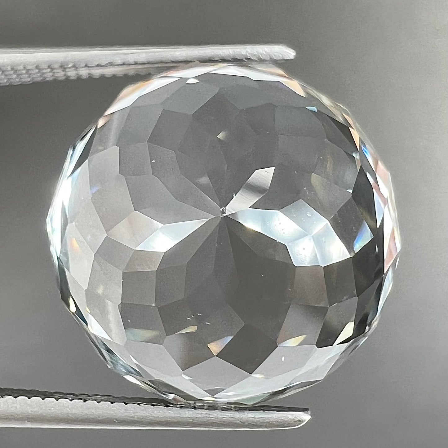 A large, round brilliant cut white topaz gemstone.