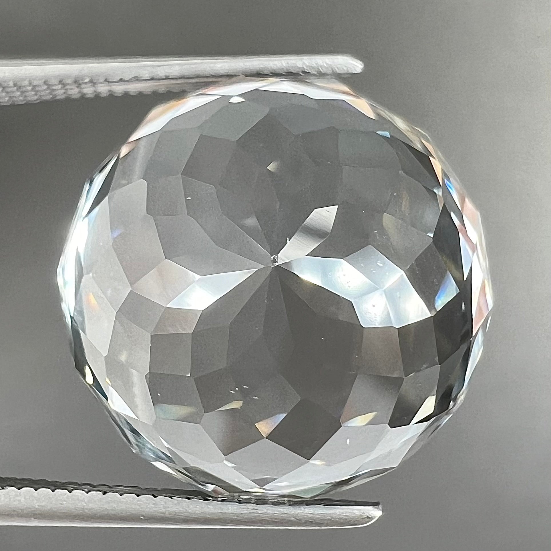 A large, round brilliant cut white topaz gemstone.