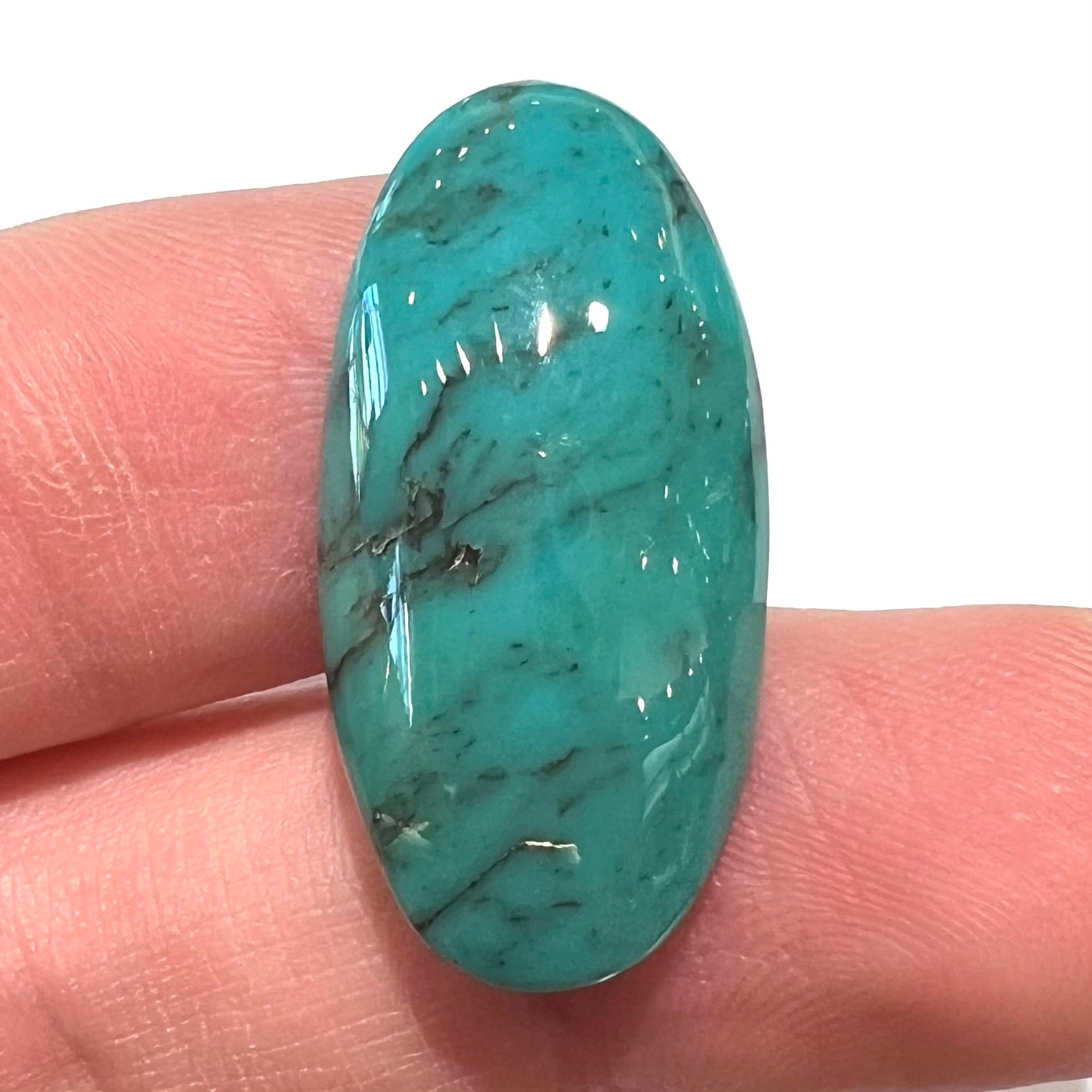 A loose, oval cabochon cut turquoise stone from Royston District, Nevada.