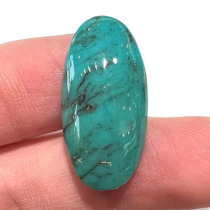 A loose, oval cabochon cut turquoise stone from Royston District, Nevada.
