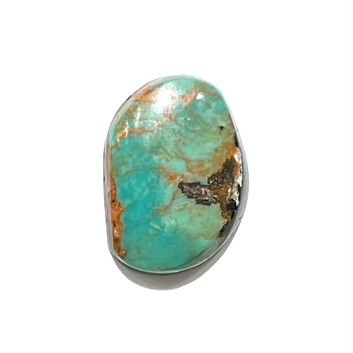 A loose, greenish blue Royston turquoise stone from Nevada.  The stone has brown and black matrix.