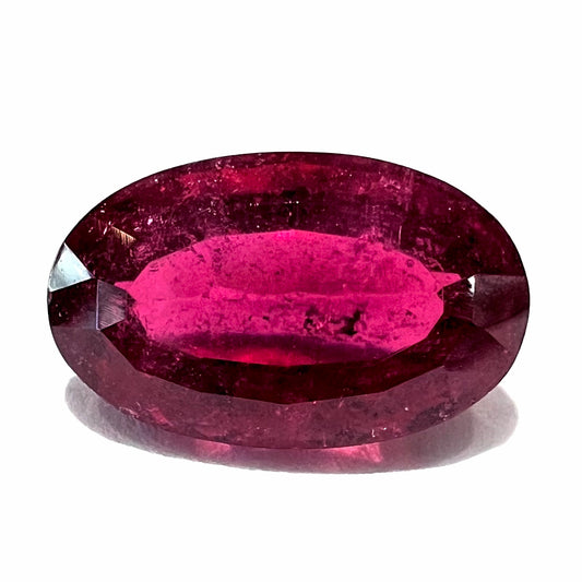 A loose, oval cut, purplish red rubellite tourmaline stone.  The gem weighs 3.14 carats.