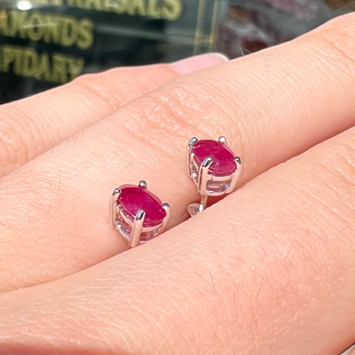 A pair of natural Burma ruby stud earrings set in white gold.  The rubies are a purplish red color.