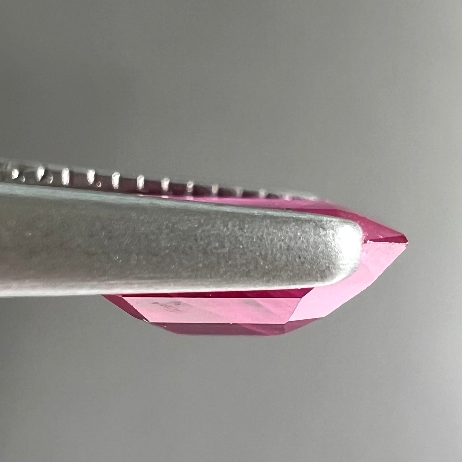 A natural, emerald cut Burma ruby gemstone.  The stone is pinkish red color.