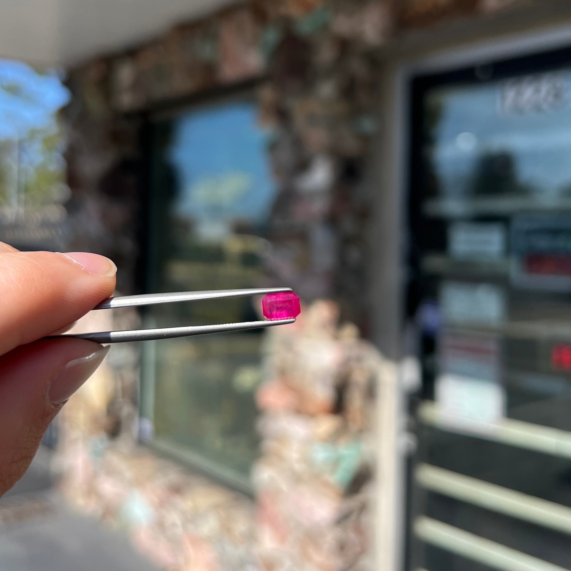 A natural, emerald cut Burma ruby with a purplish pinkish red color.