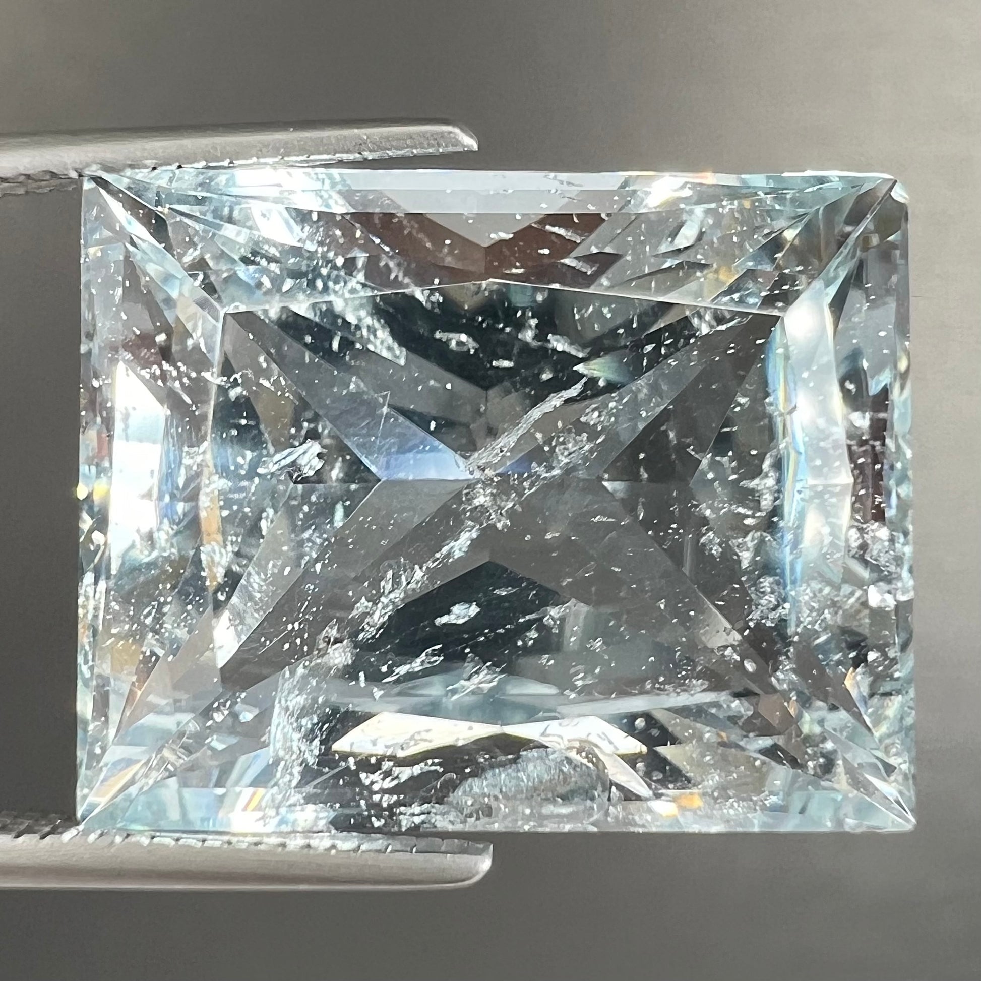 A loose, faceted French cut Russian topaz gemstone.  The stone is a light blue color.