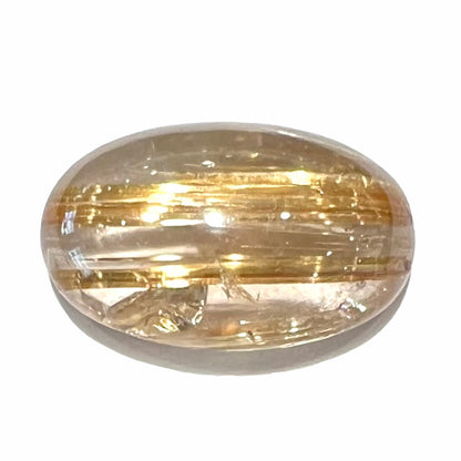 A loose, oval cabochon cut cat's eye golden rutilated quartz stone.  The gem weighs 9.74 carats.