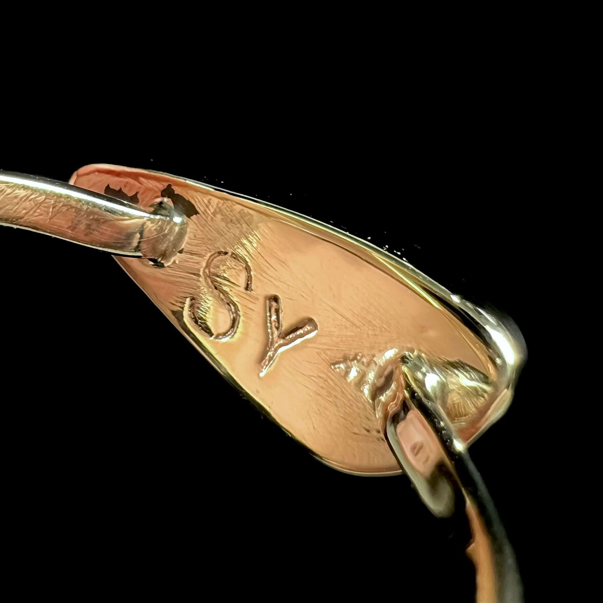 A ladies yellow gold solitaire ring bezel set with a natural opalized seashell from Coober Pedy, Australia.