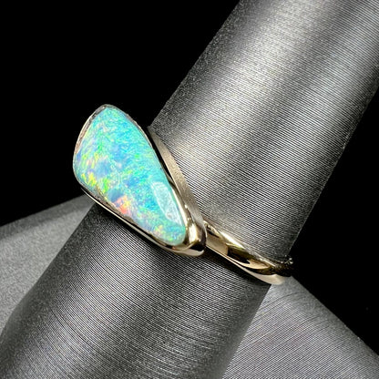 A ladies yellow gold solitaire ring bezel set with a natural opalized seashell from Coober Pedy, Australia.