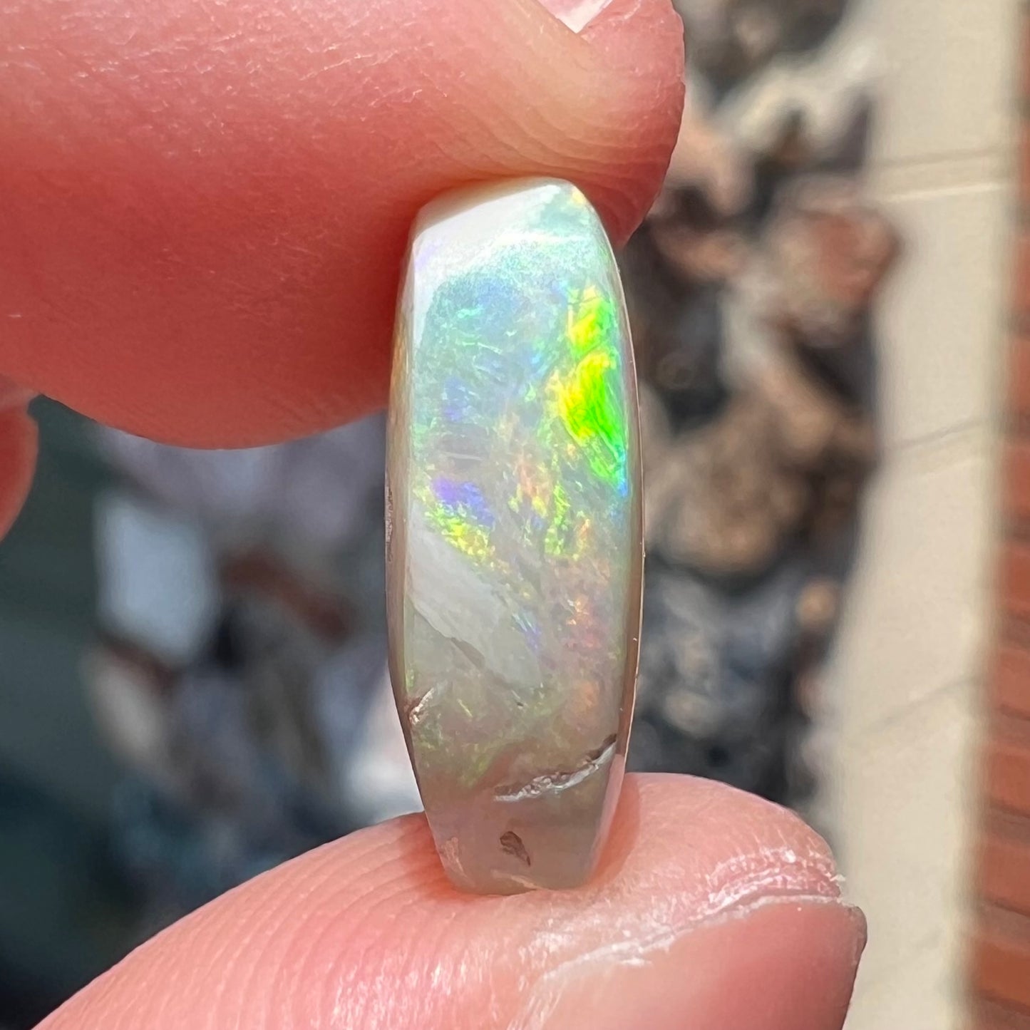 A loose, Lightning Ridge light crystal opal.  The opal is predominantly green.