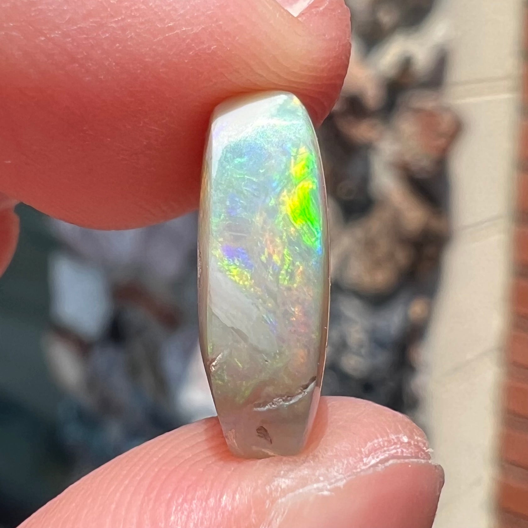 A loose, Lightning Ridge light crystal opal.  The opal is predominantly green.