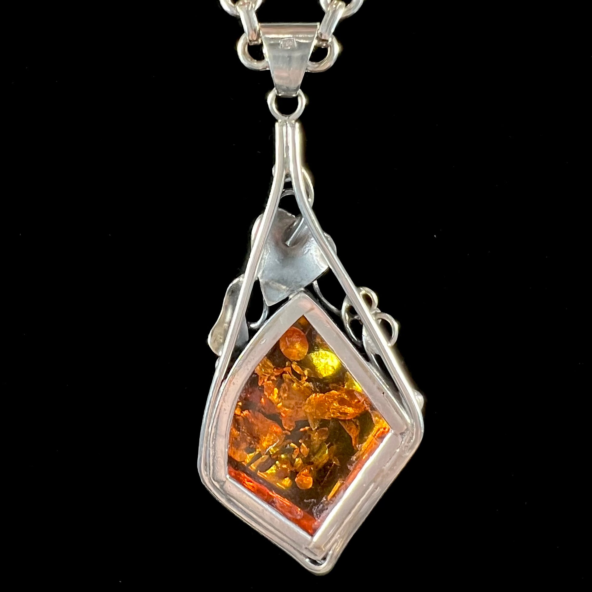Unisex silver pendant set with a sun-spangled Mexican amber stone, featuring silver leaf design accents.