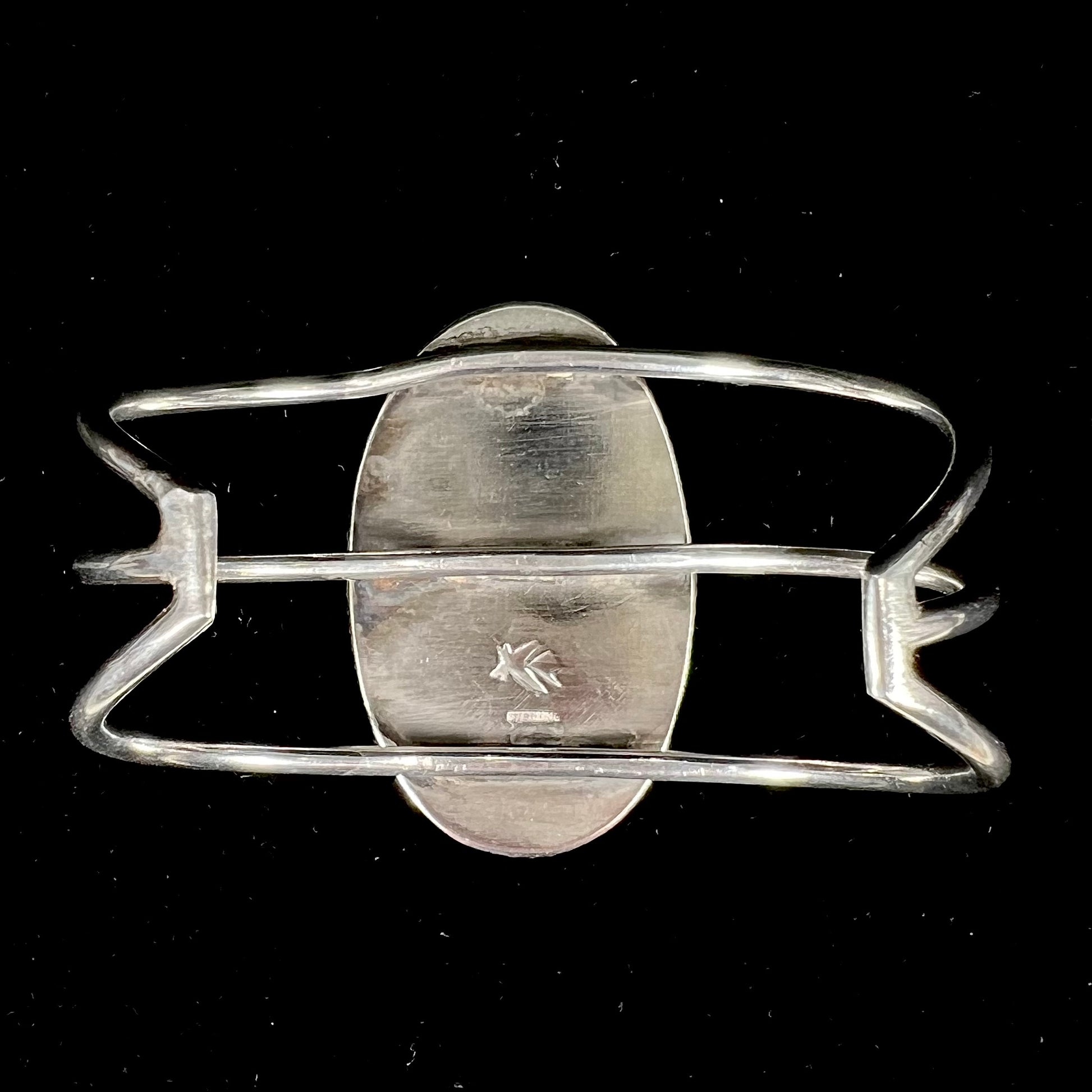 A sterling silver cuff bracelet set with a oval cabochon cut brown Biggs picture jasper stone.