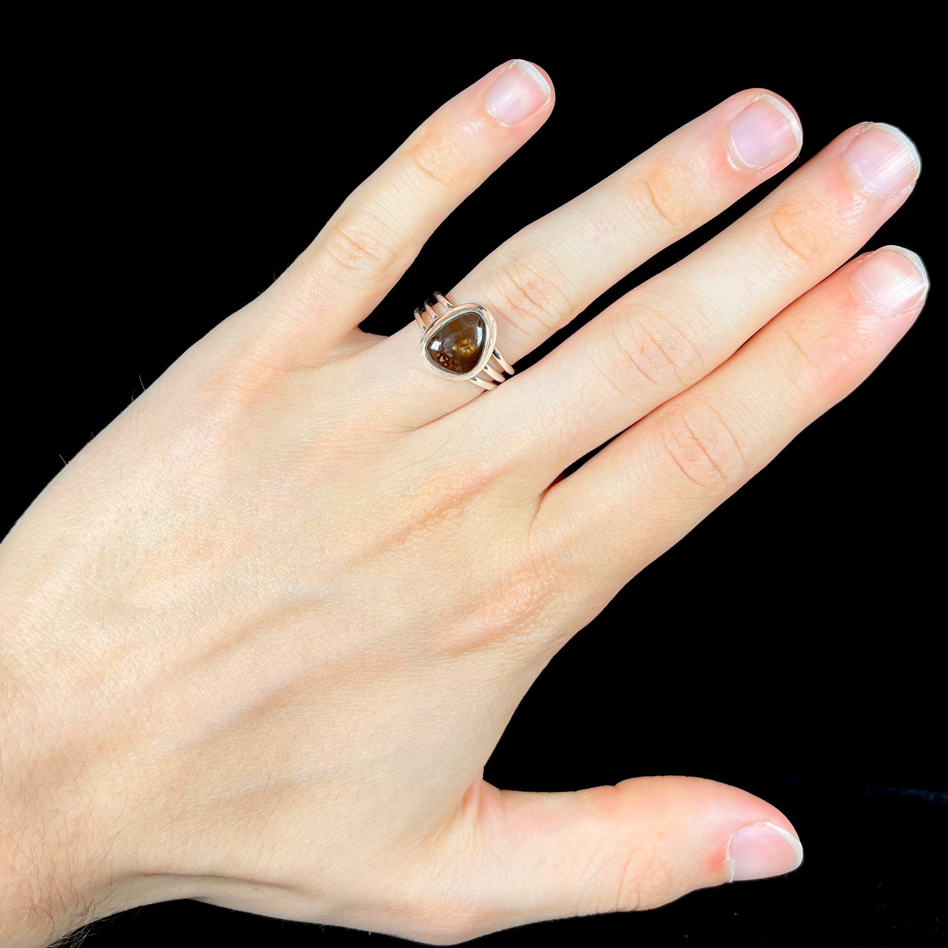 A ladies' fire agate ring set in a split-shank sterling silver mounting.