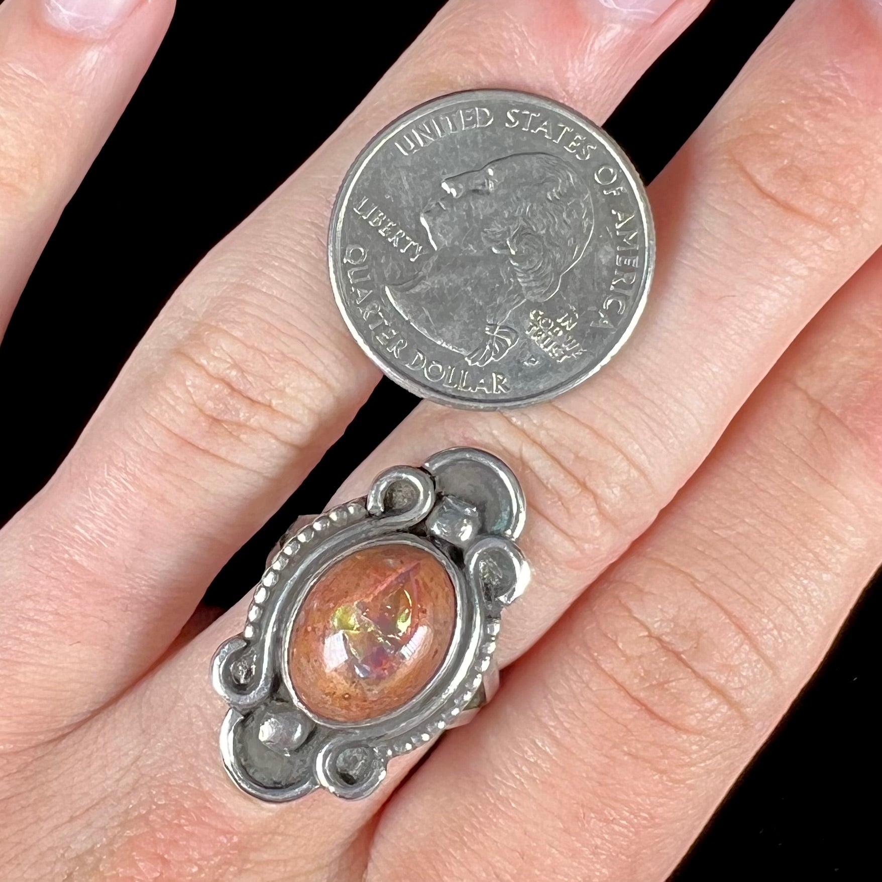 A vintage, Navajo style sterling silver ring set with an oval cabochon cut cantera fire opal stone.