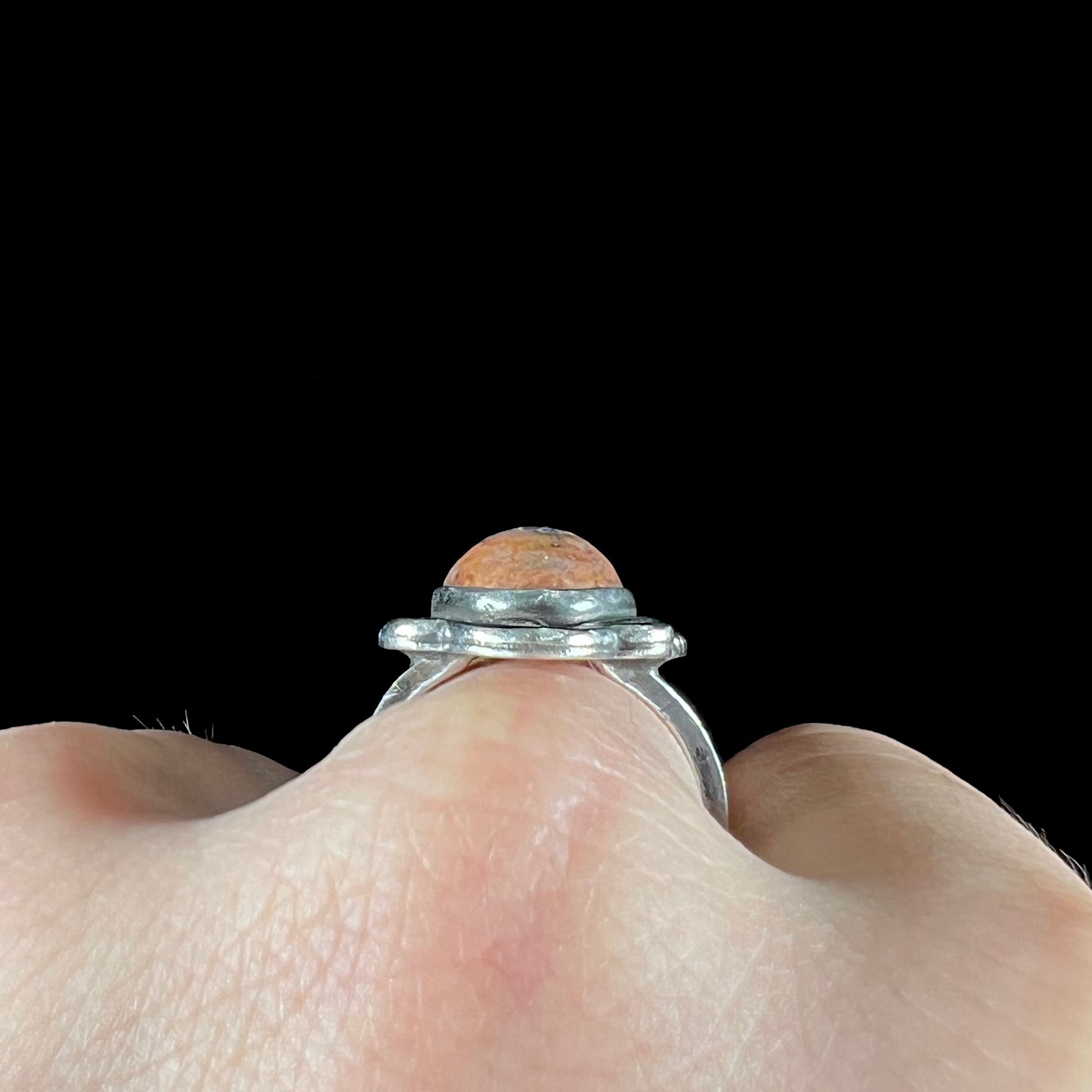 A vintage, Navajo style sterling silver ring set with an oval cabochon cut cantera fire opal stone.