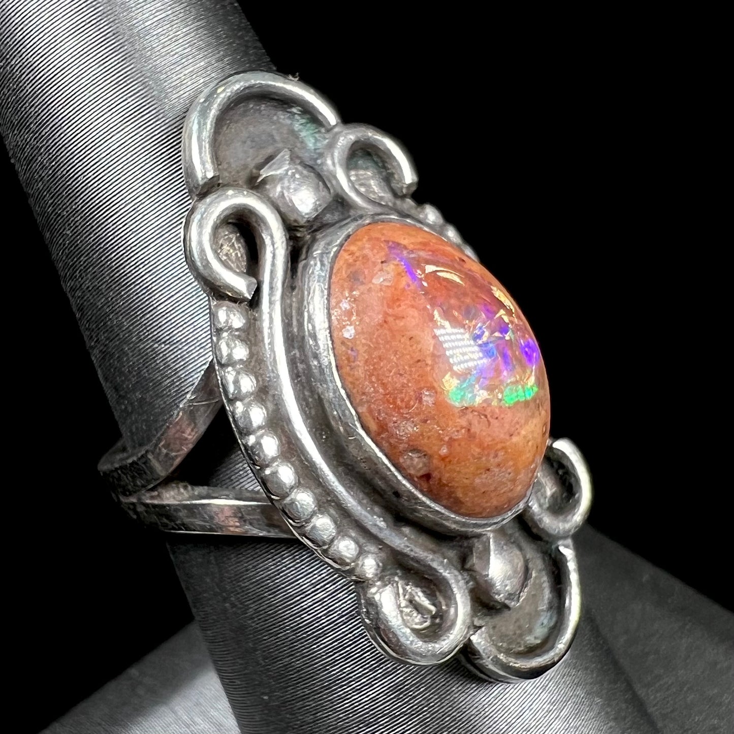 A vintage, Navajo style sterling silver ring set with an oval cabochon cut cantera fire opal stone.