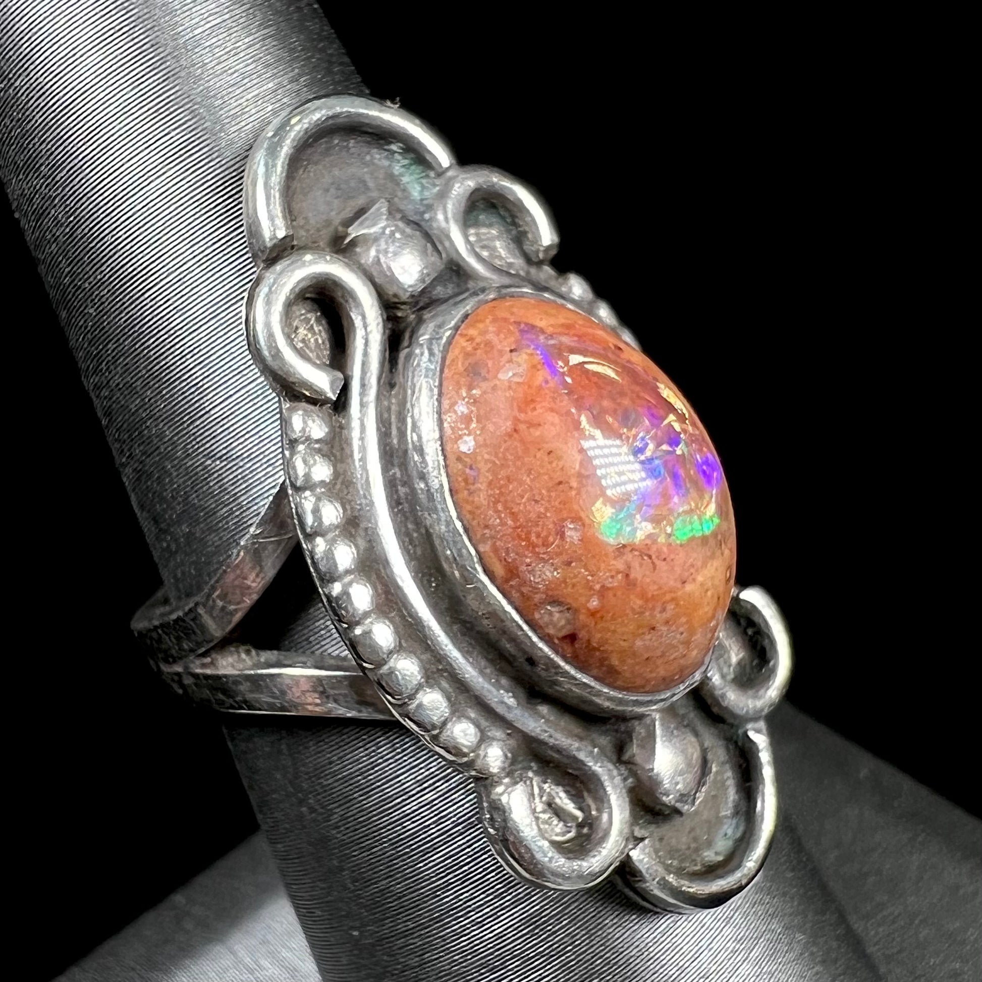 A vintage, Navajo style sterling silver ring set with an oval cabochon cut cantera fire opal stone.