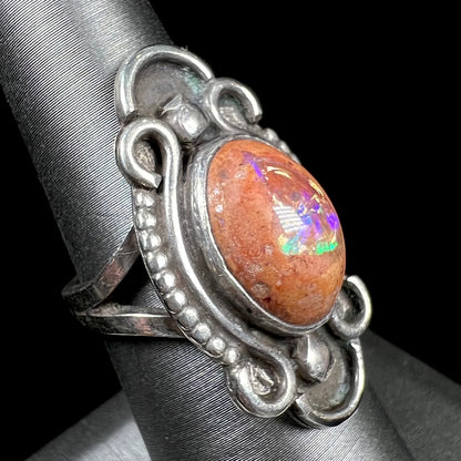 A vintage, Navajo style sterling silver ring set with an oval cabochon cut cantera fire opal stone.