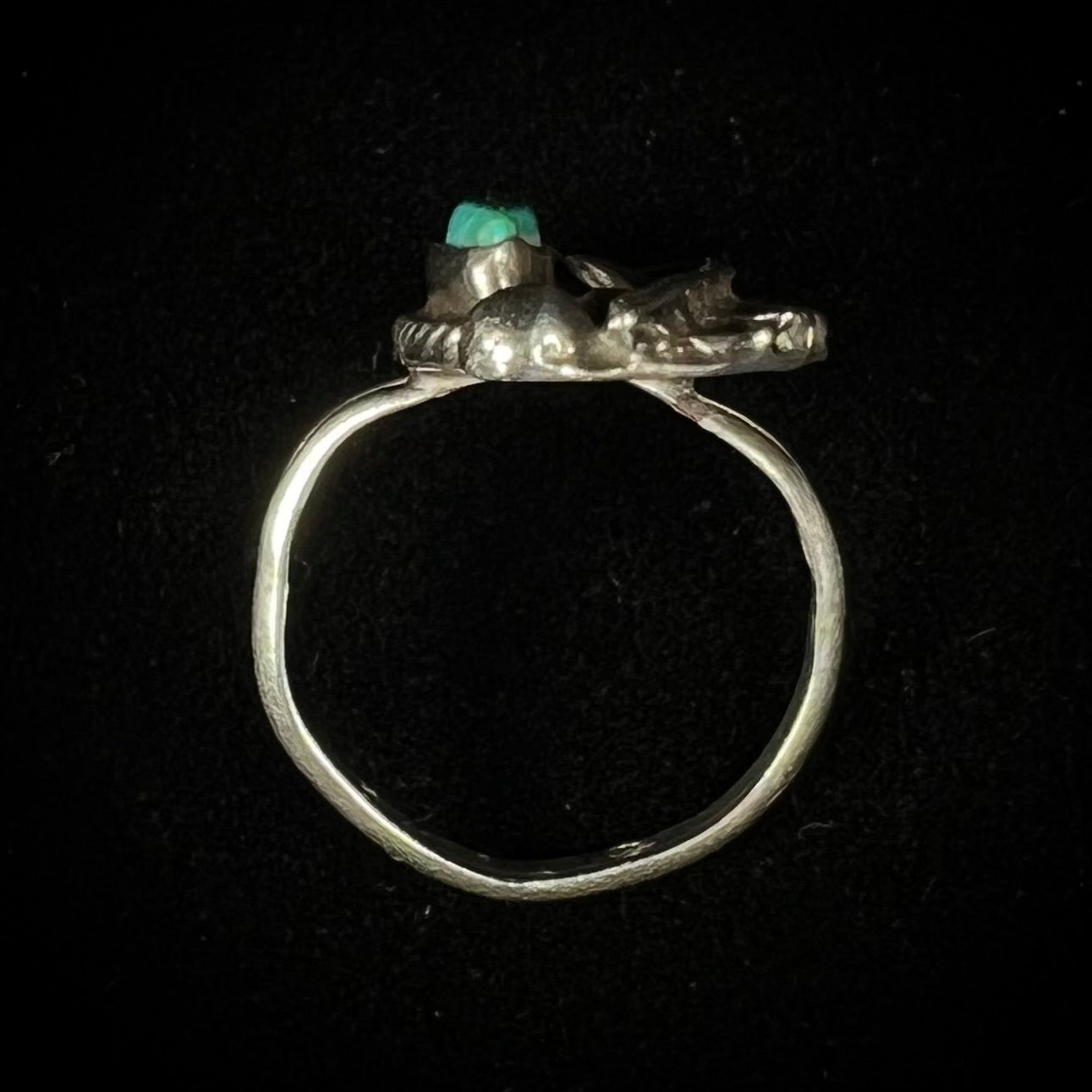 A ladies' sterling silver feather style ring set with a marquise cut turquoise stone.