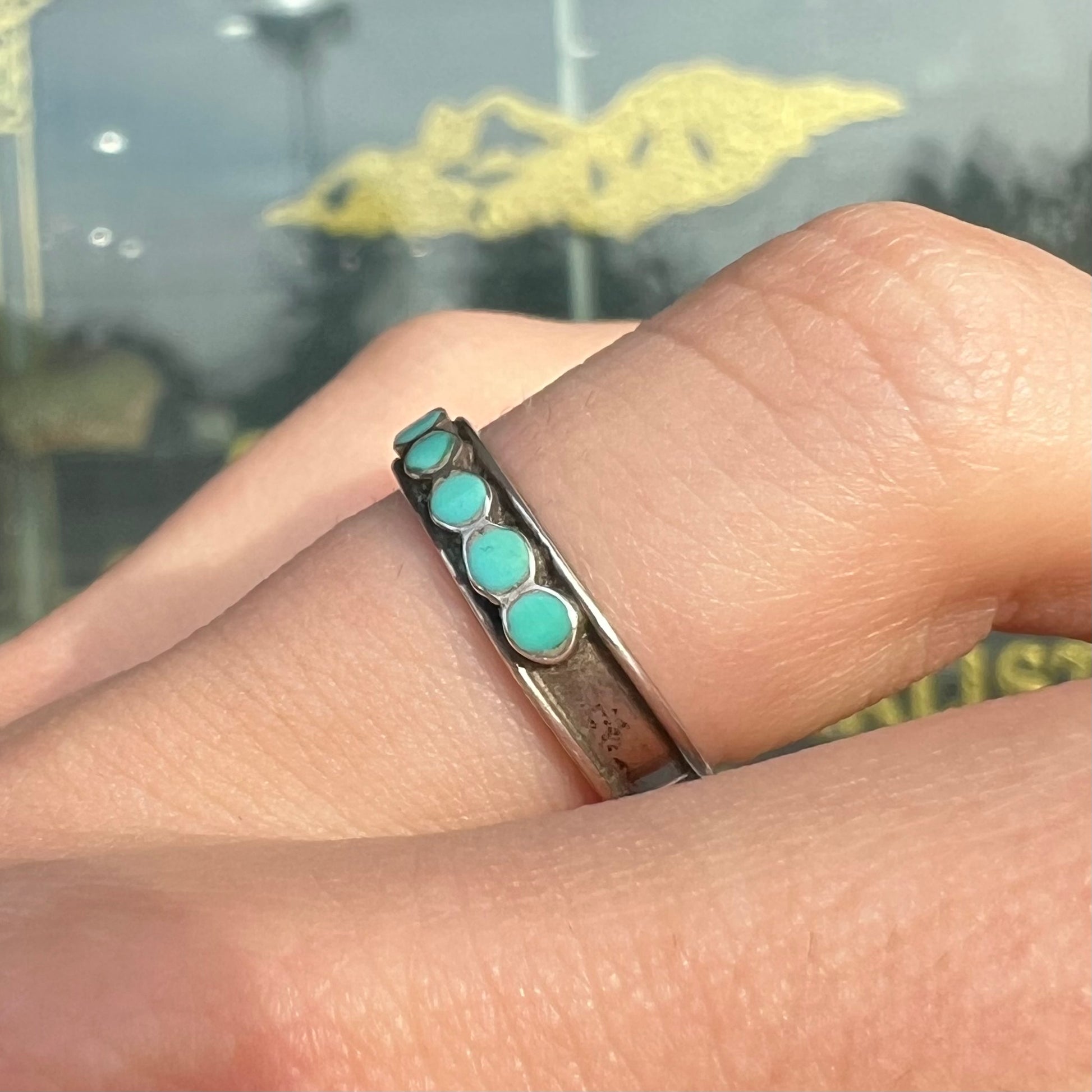 A ladies' sterling silver Hopi style band set with round cut Sleeping Beauty turquoise stones.
