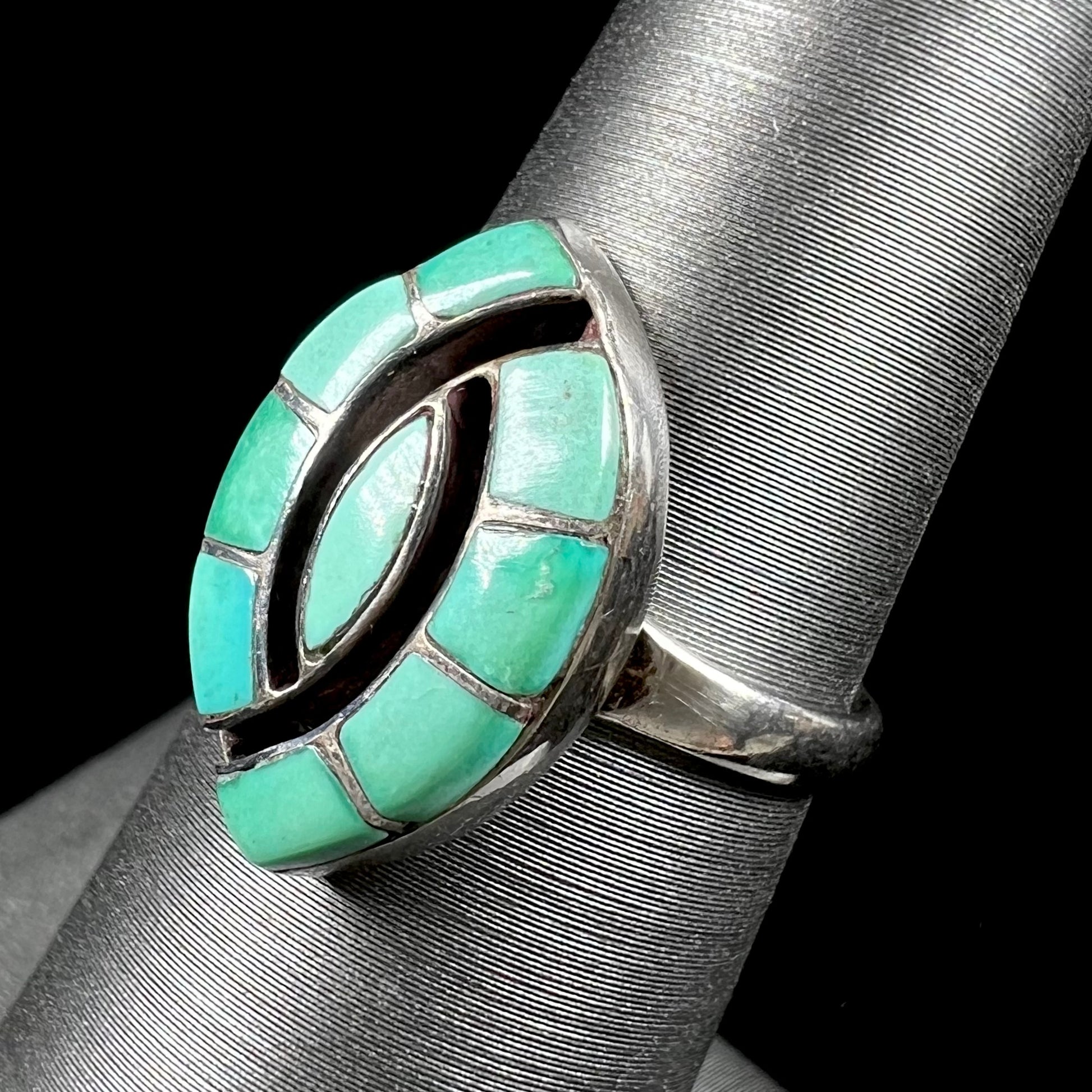 Vintage sterling silver Zuni Indian ring inlay set with green turquoise stones in the motif of a hummingbird.