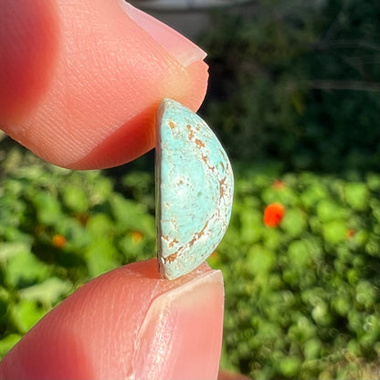 A round cabochon cut Sleeping Beauty turquoise stone.