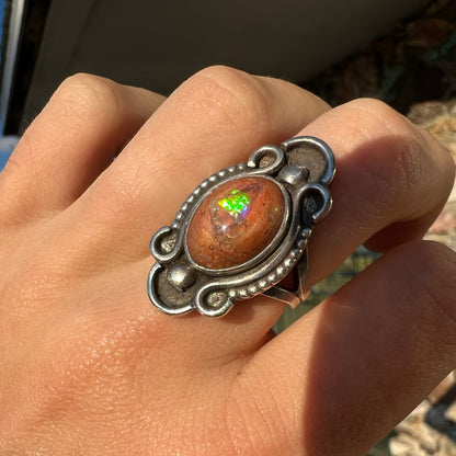 A vintage, Navajo style sterling silver ring set with an oval cabochon cut cantera fire opal stone.